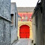 red wooden door on gray concrete building