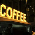 a coffee shop sign lit up at night