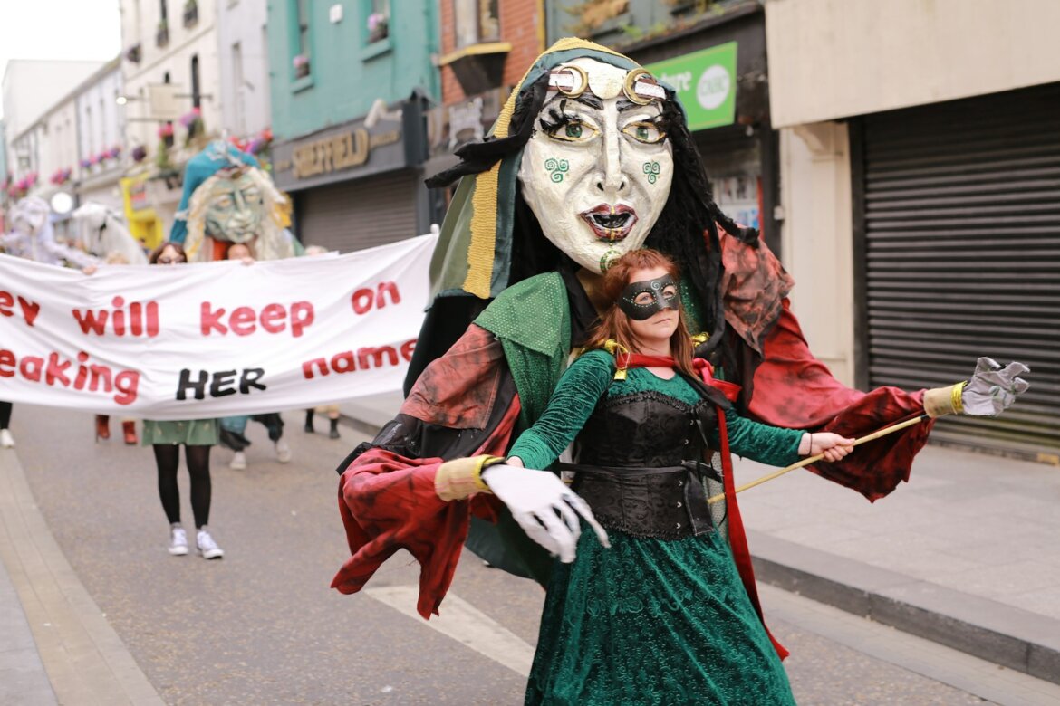 People in costumes and masks at a parade