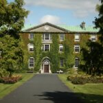 a large green building with a clock on it's face