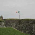 a flag on top of a stone wall