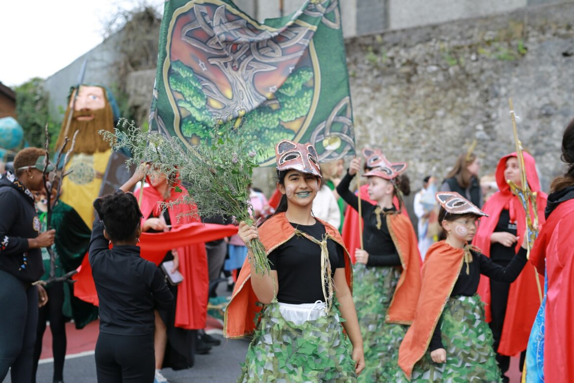 Children in costumes participating in a parade