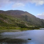 a body of water with mountains in the background