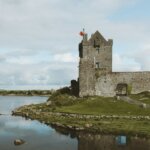 gray concrete building near body of water during daytime