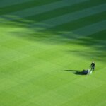 aerial photography of person trimming sports field during day
