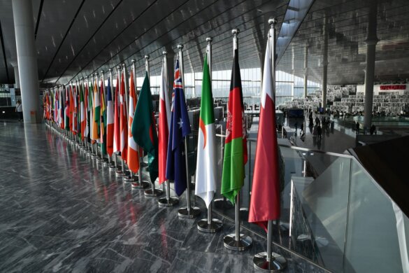 Row of national flags displayed indoors